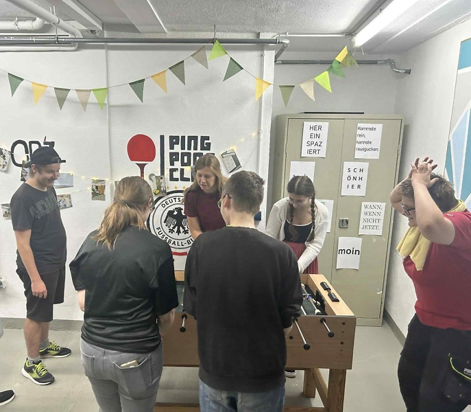 Azubis spielen Tischfu&szlig;ball im Freizeitraum